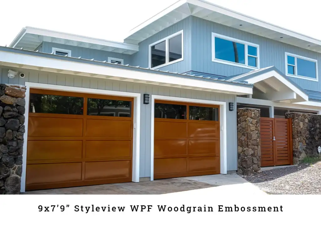 White steel garage doors on a blue island home